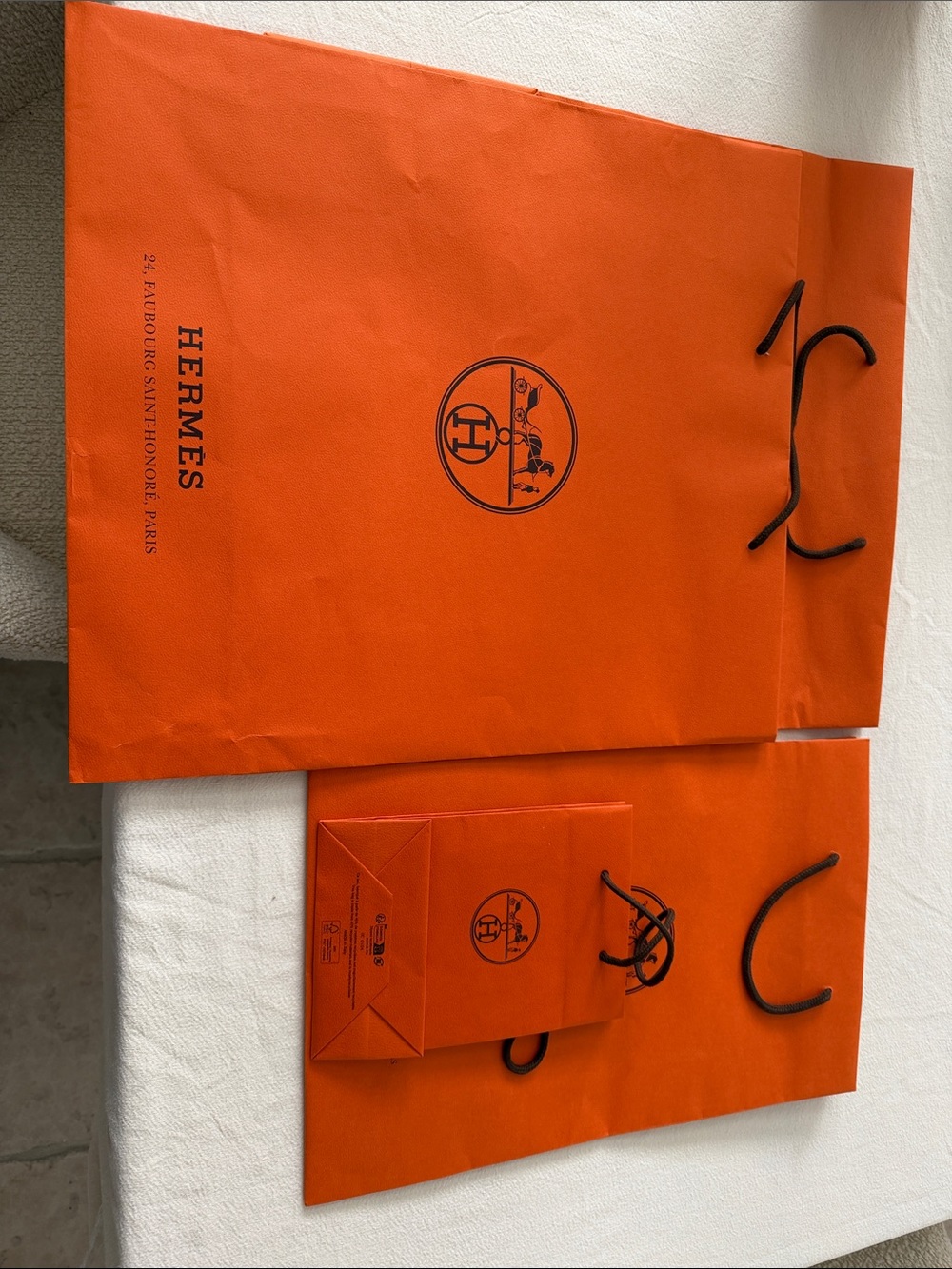 Hermès Orange Shopping Bags with Black Logo and Handles